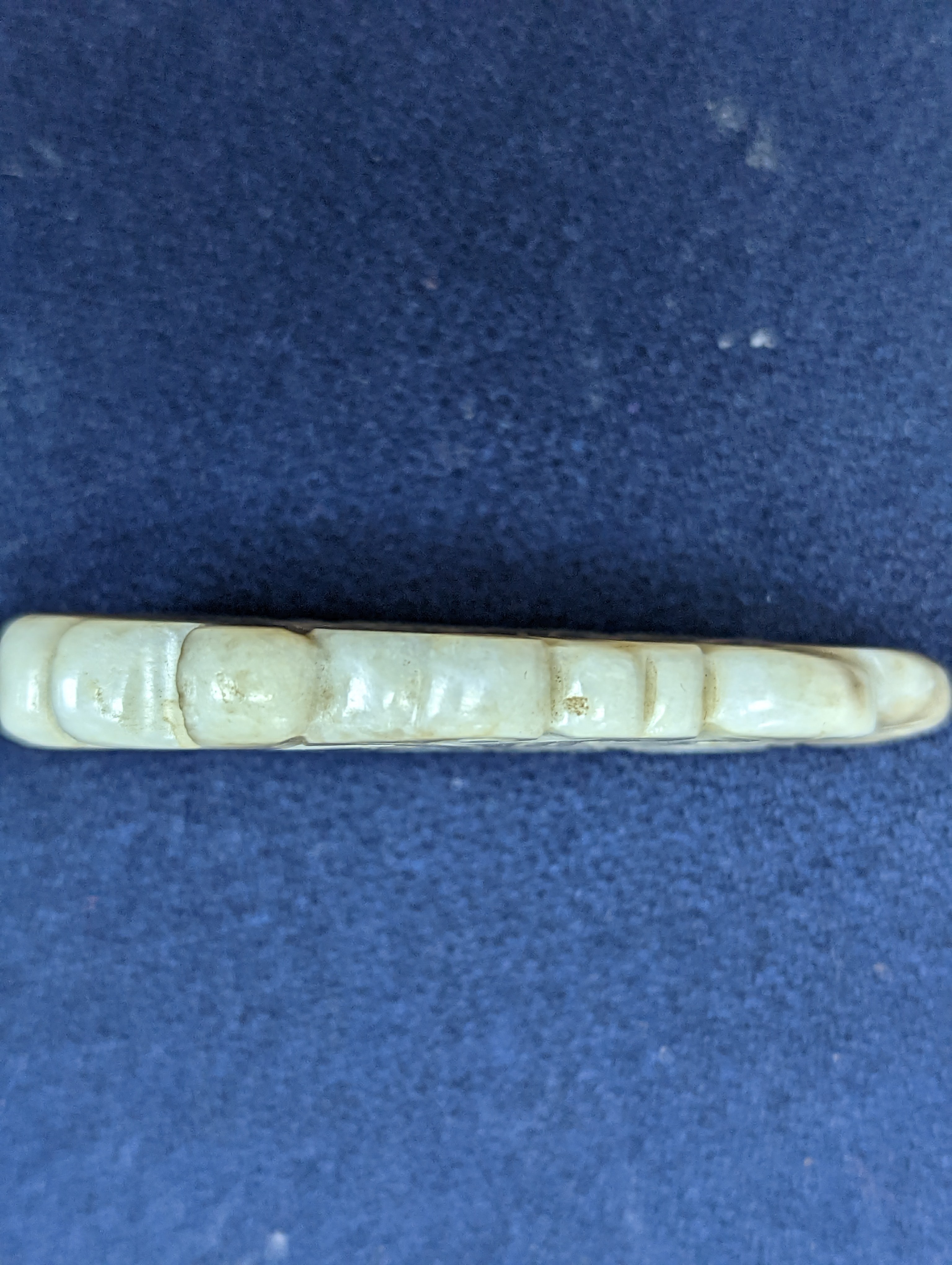A Chinese white and black jade ‘dragon-fish’ plaque, 19th/20th century, 6cm